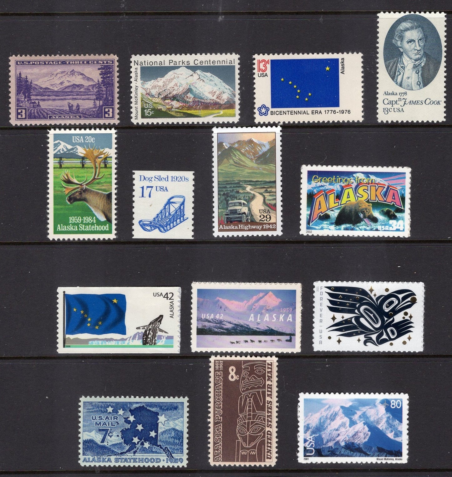 ALASKA STAMP COLLECTION #1 - 14 Stamps with Alaskan Scenes, Raven Story, State Flag, Mt McKinley, Cook, Dog Sled - 1937-on FreeUSA Ship